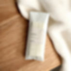 equinox wax melt snap bar on a wooden tabletop with a cream colored blanket.