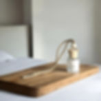 gather car diffuser sitting on a wooden tray.