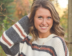 A lifestyle image of a model wearing a sweater