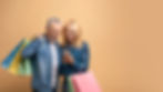 happy-senior-couple-with-shopping-bags-using-cell-2023-11-27-04-49-59-utc.jpg