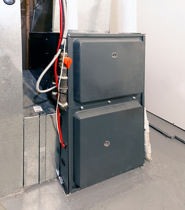 A home high energy efficient furnace in a basement.jpg