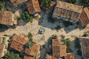 Battlemap d’un village médiéval avec une fontaine centrale et des maisons en pierre pour jeu de rôle