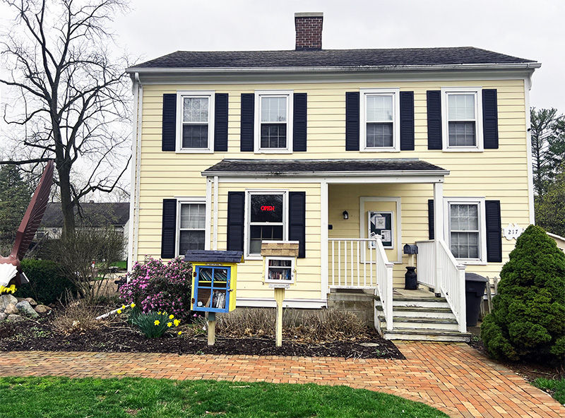 Eye-level view of the historic Eagle town hall building surrounded by trees