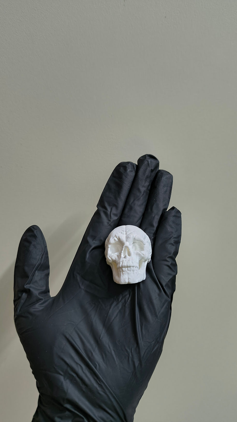 Bone Chiller skull magnet held in hand