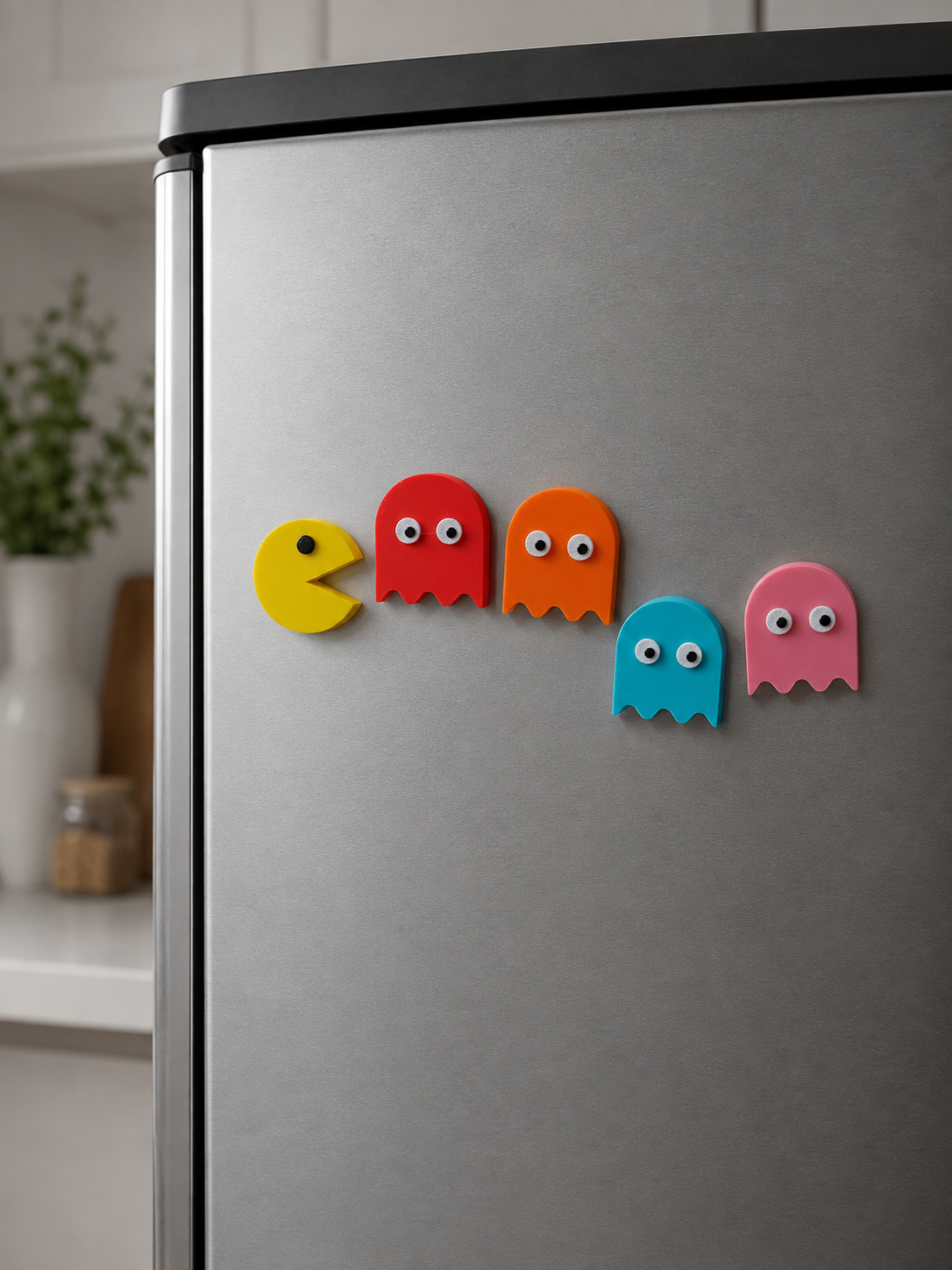 Pixel Chase colorful Pac-Man inspired fridge magnets displayed on a refrigerator