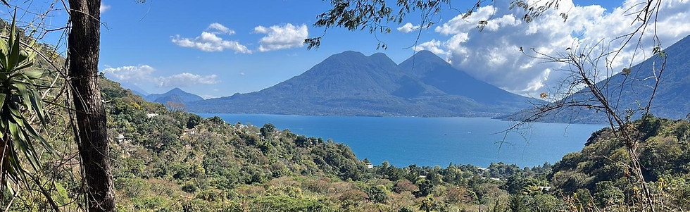 from the land a picture overlooking Lake Atitlan on a sunny day.