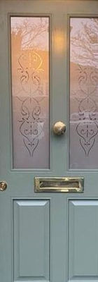 Door with etched glass and brass ironmongery