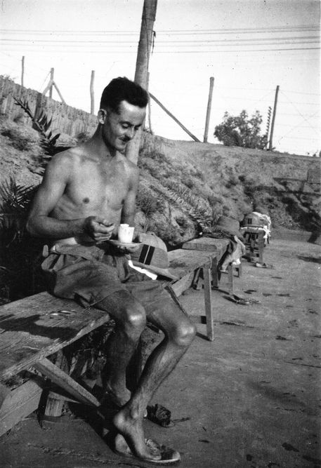 This photo was taken of an airman at RAF Hinaidi sitting on a bench by the side of the swimming pool