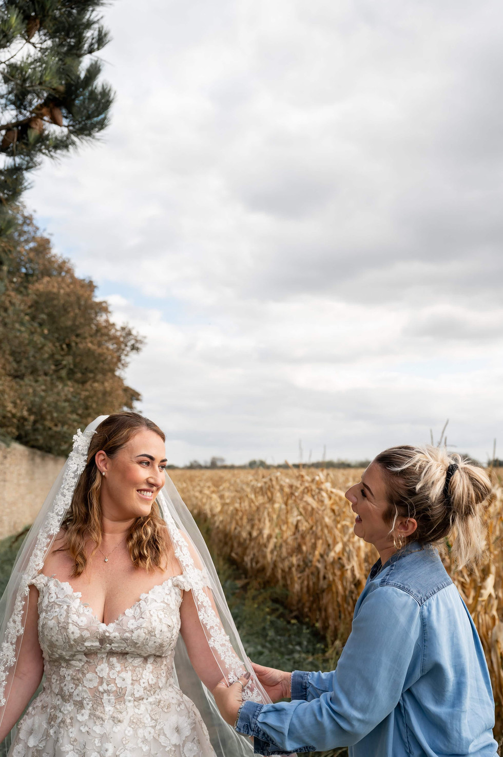Bride wearing a veil standing in a wheat field during Redress Studio’s Liverpool wedding dress photoshoot.