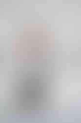 Coach holding a laptop and smiling, captured in clean and modern Liverpool studio photography.