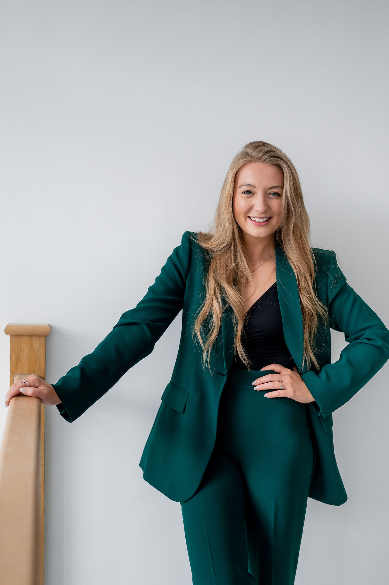 Manchester womens health coach standing in green suit during branding photoshoot.