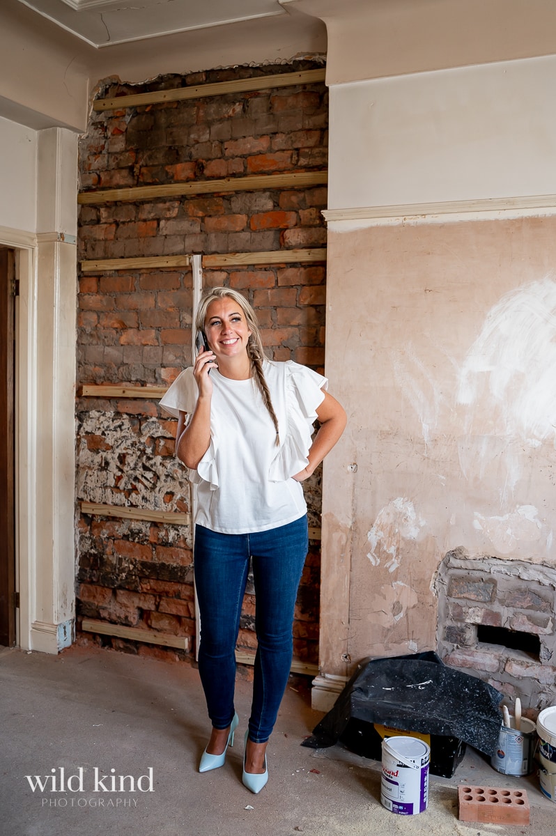 Property investment educator on phone in Liverpool flat renovation.