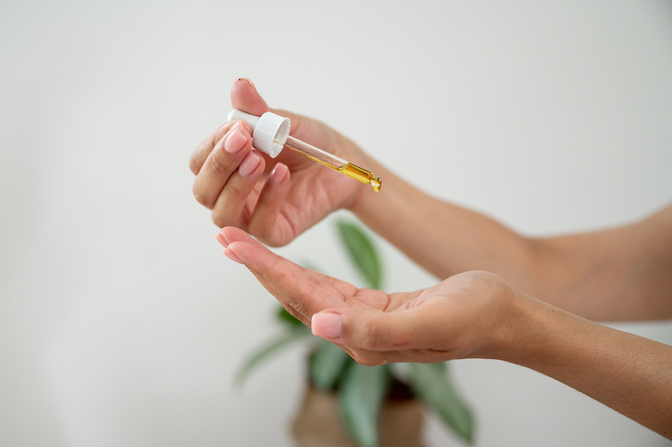 Close-up of a dropper applying serum during a luxury skincare brand photoshoot for Abeni Lane in Liverpool.