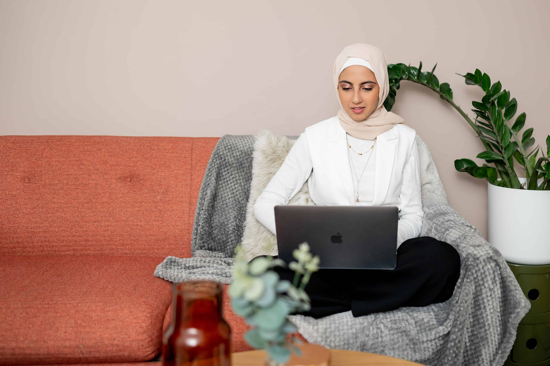Working on couch on laptop during Liverpool brand photoshoot with Fitra Nutrition.