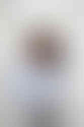 Portrait of the Abeni Lane founder standing by her inspiration wall during her luxury skincare brand photoshoot.