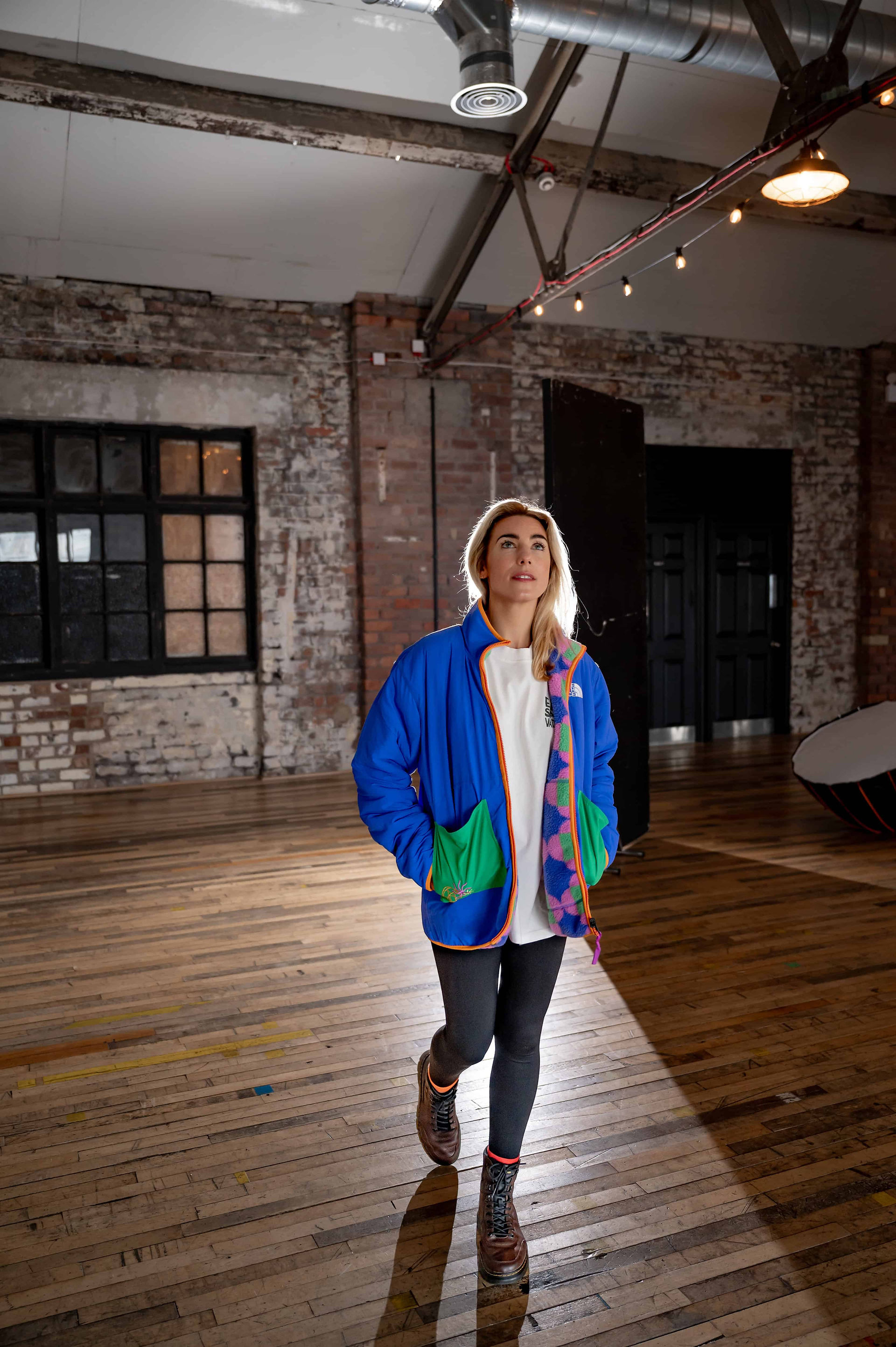 Faye Newton walking through the open studio at Scale Liverpool, known for hosting creative and film industry shoots