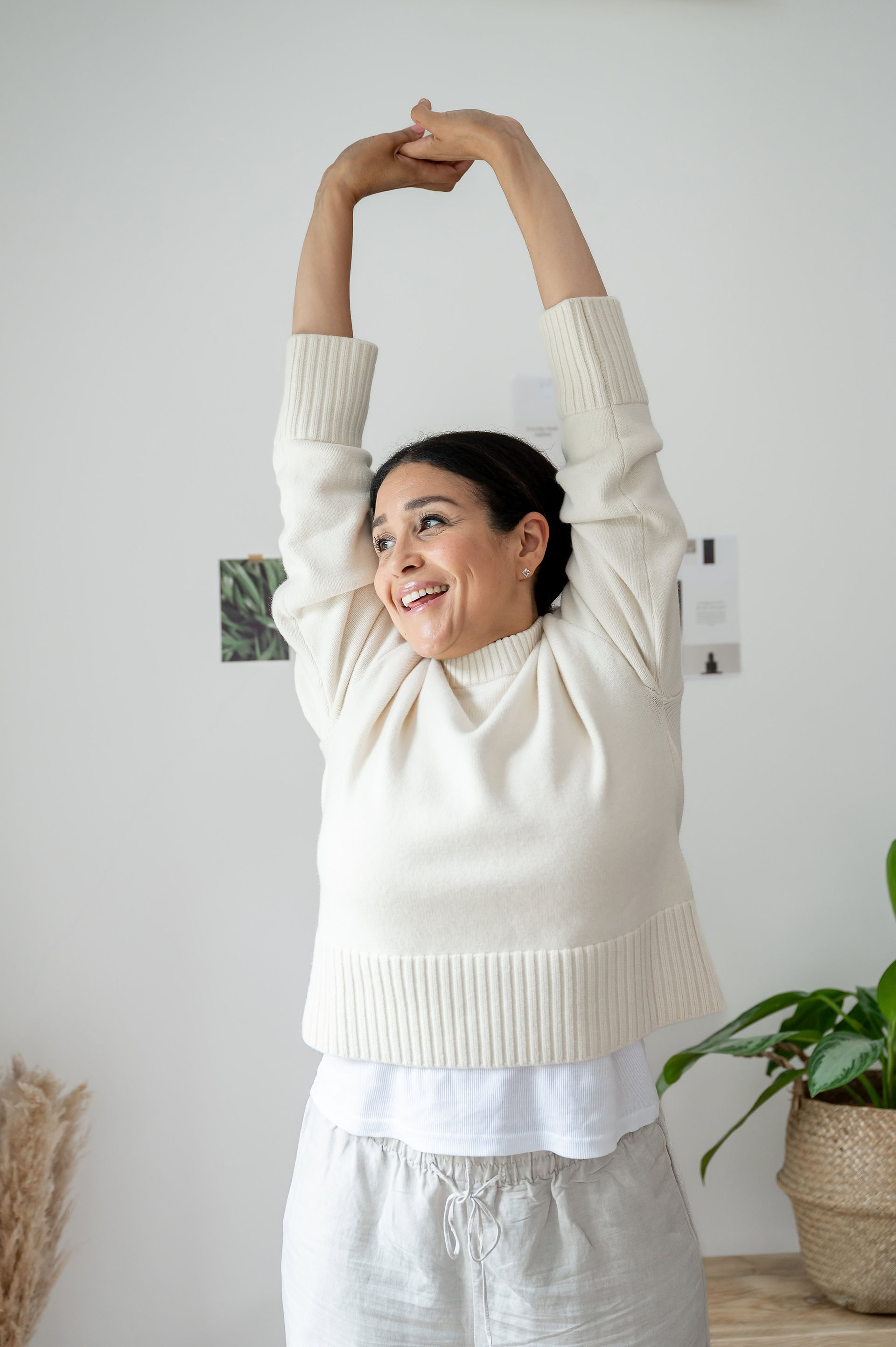 Abeni Lane founder stretching with a smile during her relaxed luxury skincare brand photoshoot.