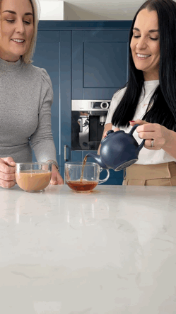 Gif of women pouring tea from teapot in kitchen.
