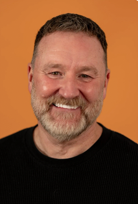 Paul Thompson, Managing Director of Westminster Associates headshot and personality image of vinyl records, with new brand color backdrops.