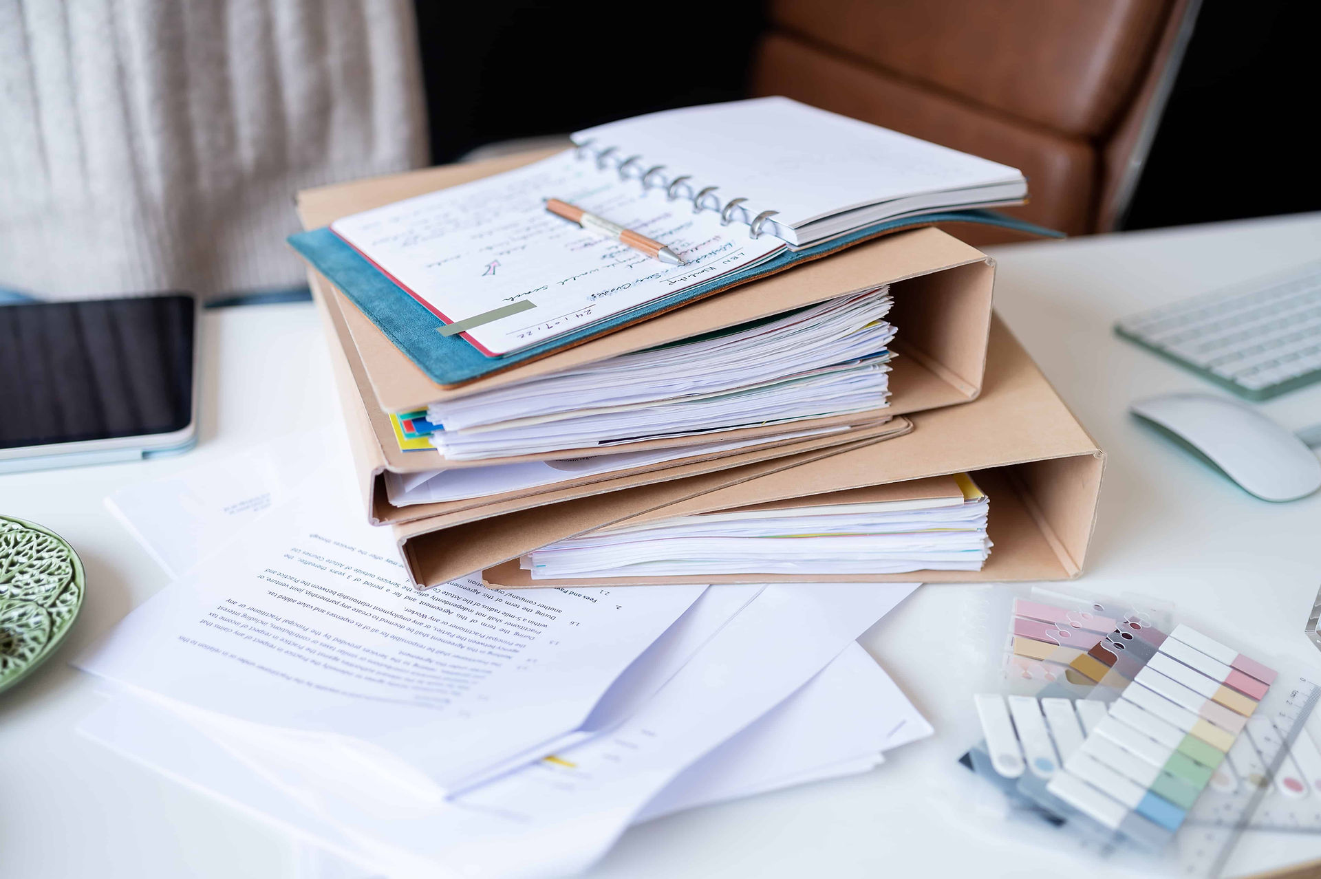 Leicester contract lawyer desk filled with paperwork at brand photoshoot.