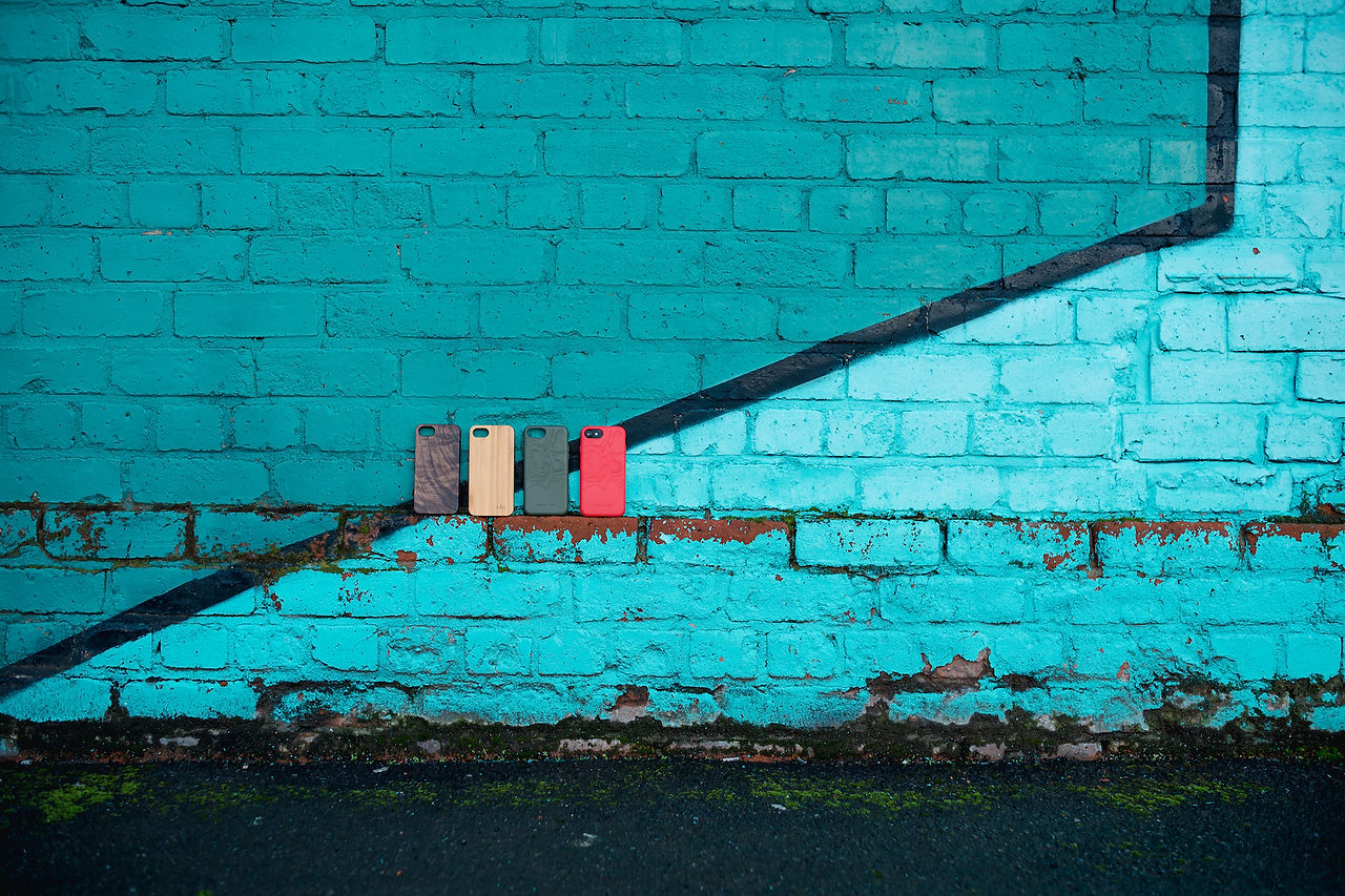 Phones in front of colorful Liverpool building on Mann Street