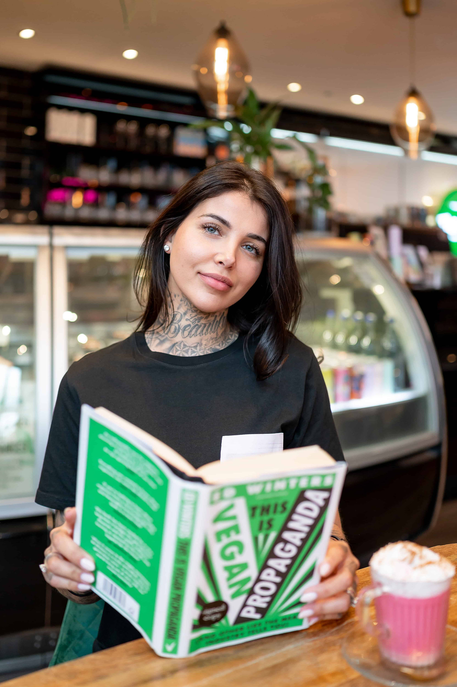 Liverpool Plant Based app creator reading Ed Winter's book, Vegan Propaganda, at the Vibe.