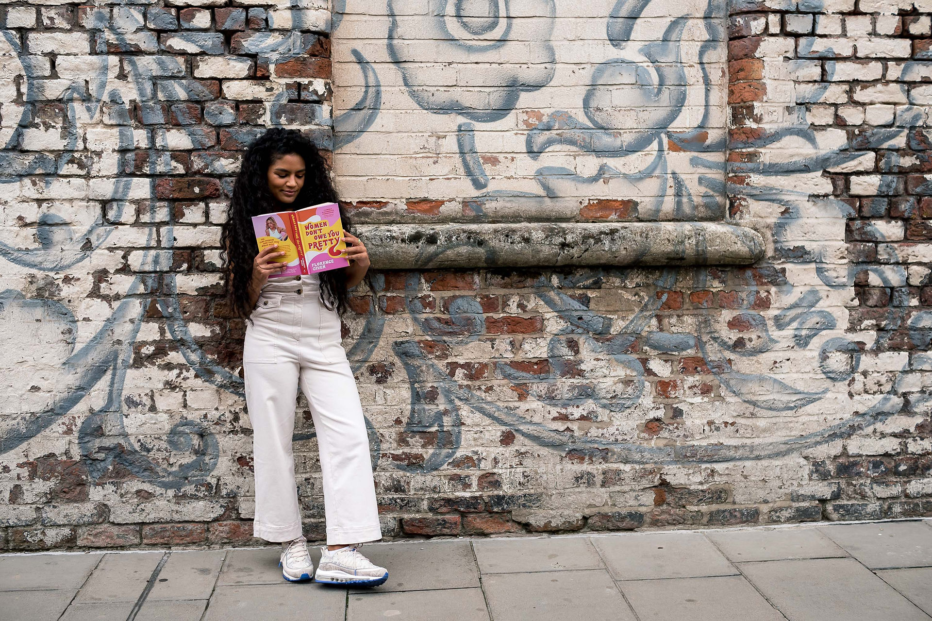 Woman in front of art on Jamaica street Wings in Liverpool