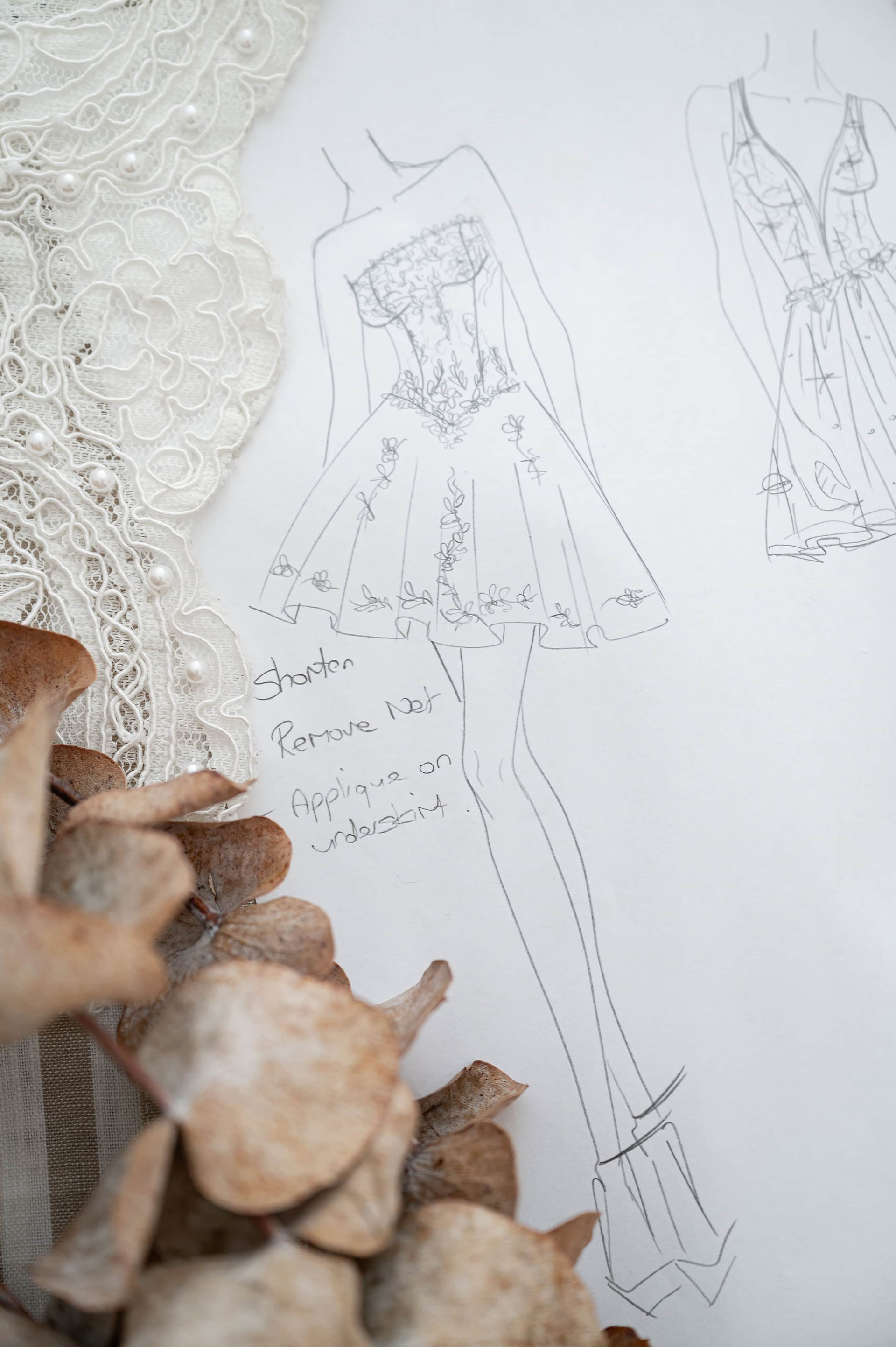 Hand-drawn wedding dress sketch with lace appliqué details photographed for Redress Studio’s Liverpool alterations branding.