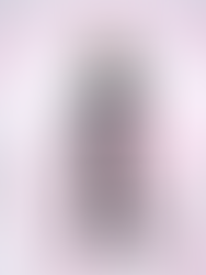 A woman in a green suit stands centered inside an optical illusion made from a large pink slinky spiraling toward her.