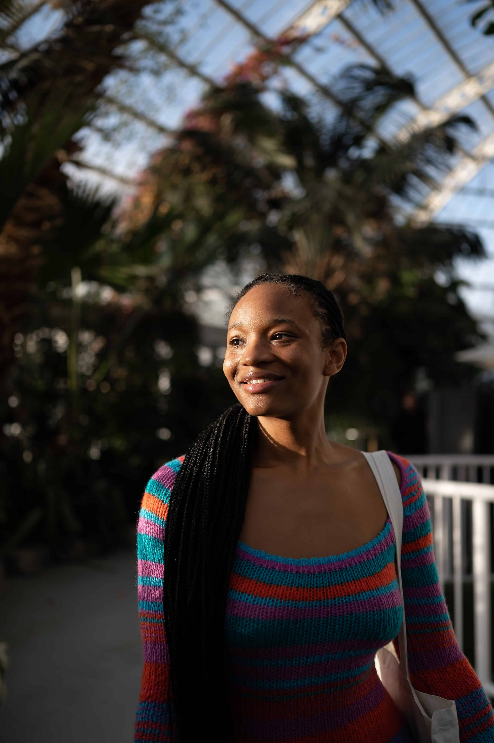 Tamiqua the Herbalist smiling in the sunshine at Liverpool's Sefton Palm House.