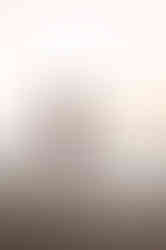 Hypnotherapist in white dress in water at Ainsdale Beach.