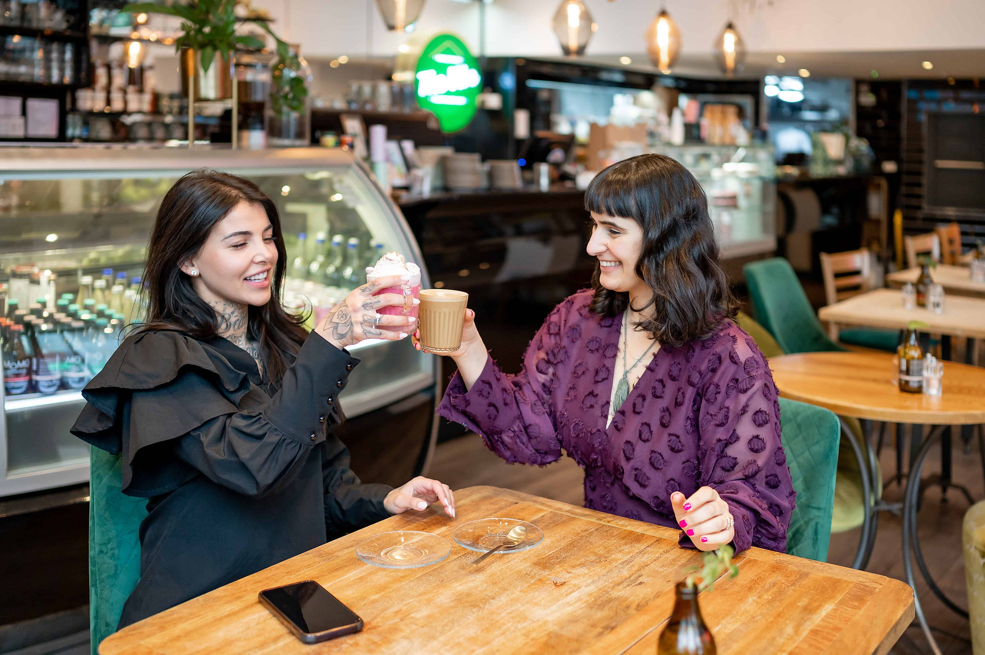 Liverpool Plant Based app creator with owner of The Vibe, toasting.