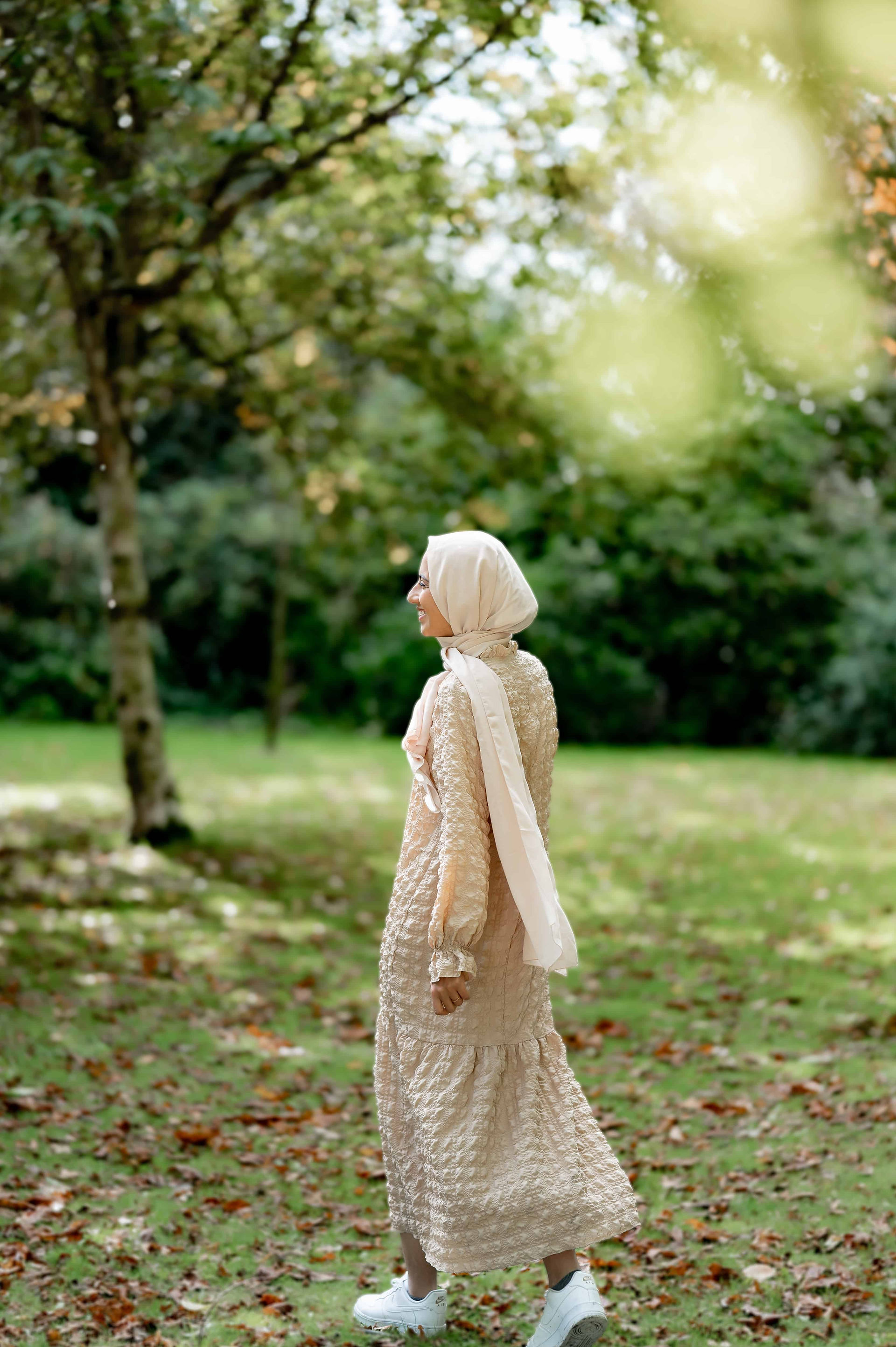 Muslim nutritionist walking through Liverpool park.