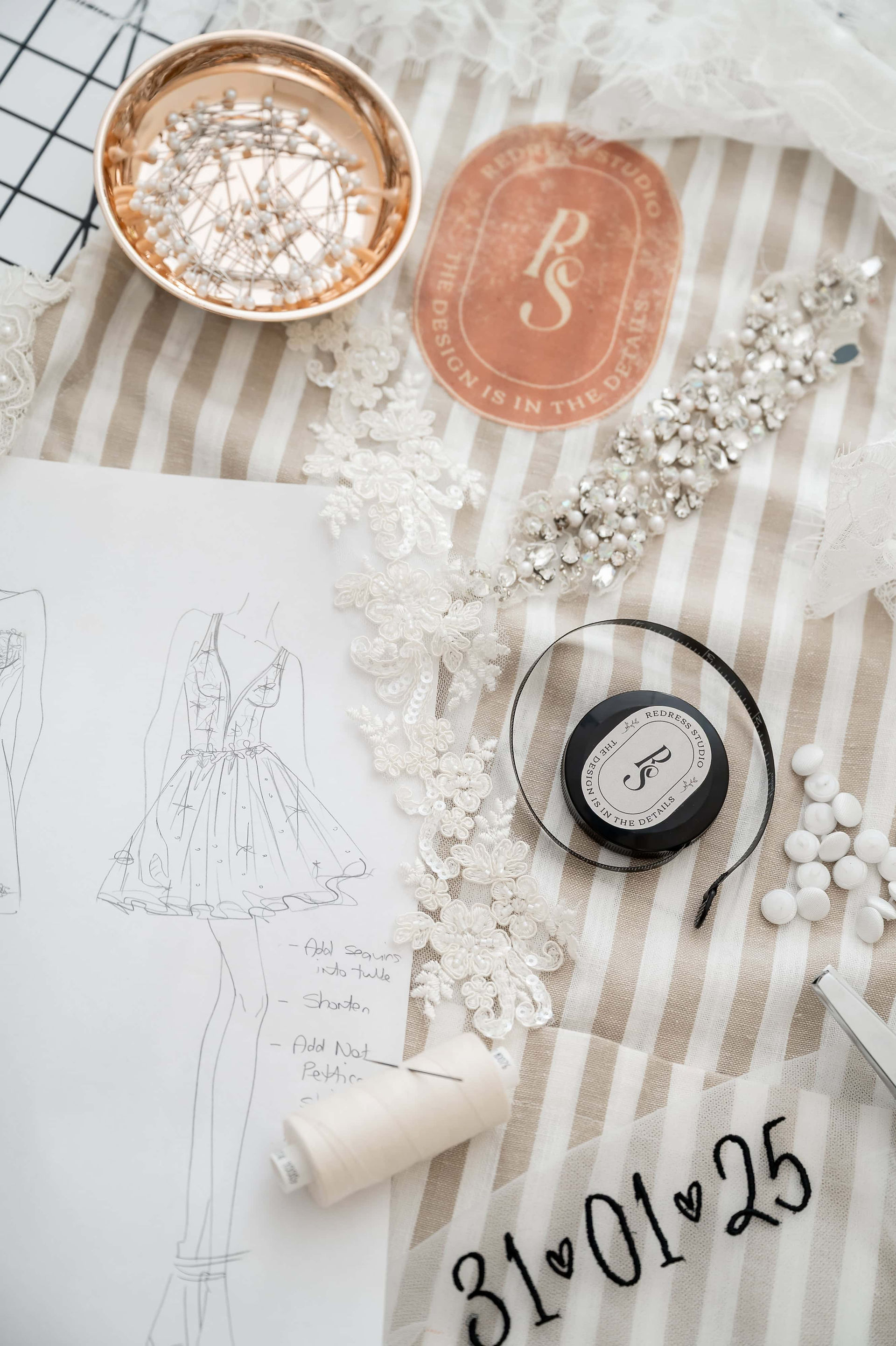 Bridal sketches and embellishments laid out by Liverpool veil designer Redress Studio during a wedding industry brand photoshoot.