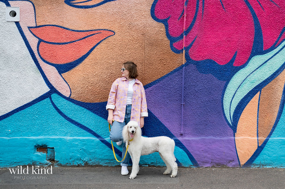 London SEO expert with poodle against Walthamstow street art.