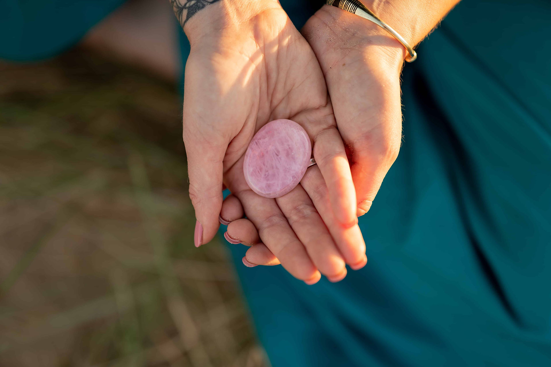 Hypnotherapist holding pink worry stone.