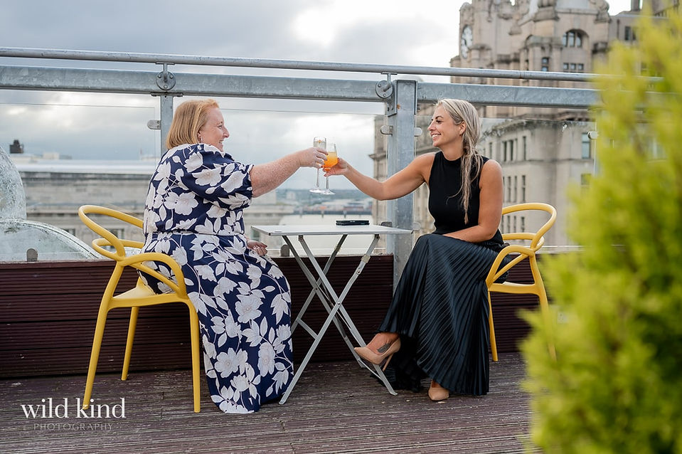 Property Investment colleagues toasting on rooftop bar in Liverpool