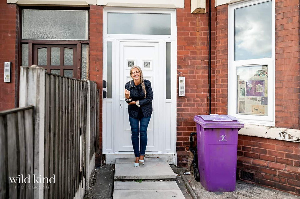 Property investment expert outside of Liverpool flat being renovated.