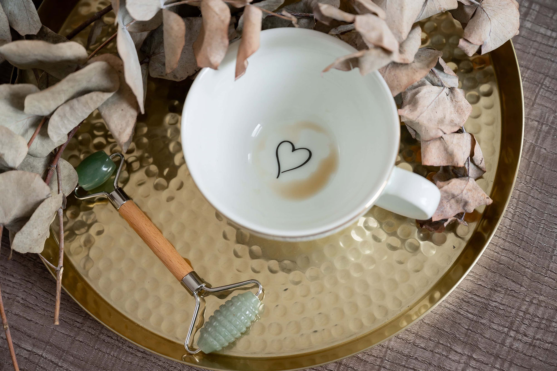 Gold tray with jade roller and mug during an Abeni Lane Skincare luxury branding shoot.