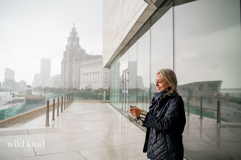 Property Investment expert texting on the Liverpool waterfront.
