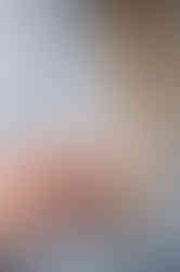 Close-up of Emily holding folded paper heart in hand