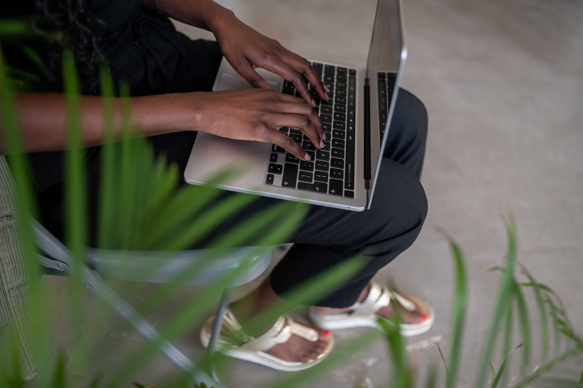 Social Media Manager on laptop in Manchester studio.