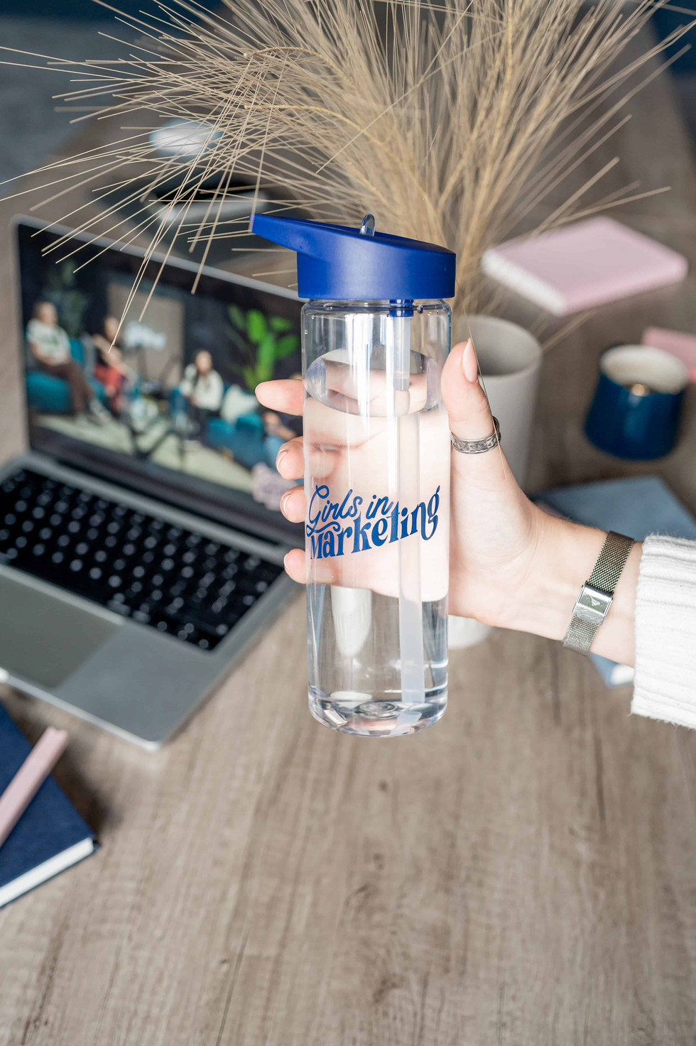 Girls in Marketing waterbottle in hand.