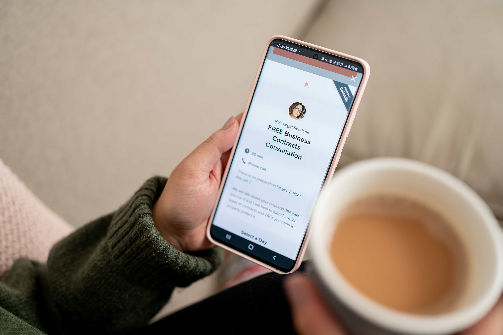Leicester contract lawyer looking at contact form on phone with english breakfast tea.