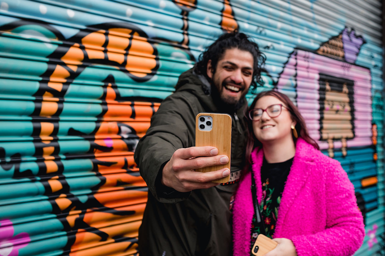 Couple with cat street art in Baltic Triangle in Liverpool
