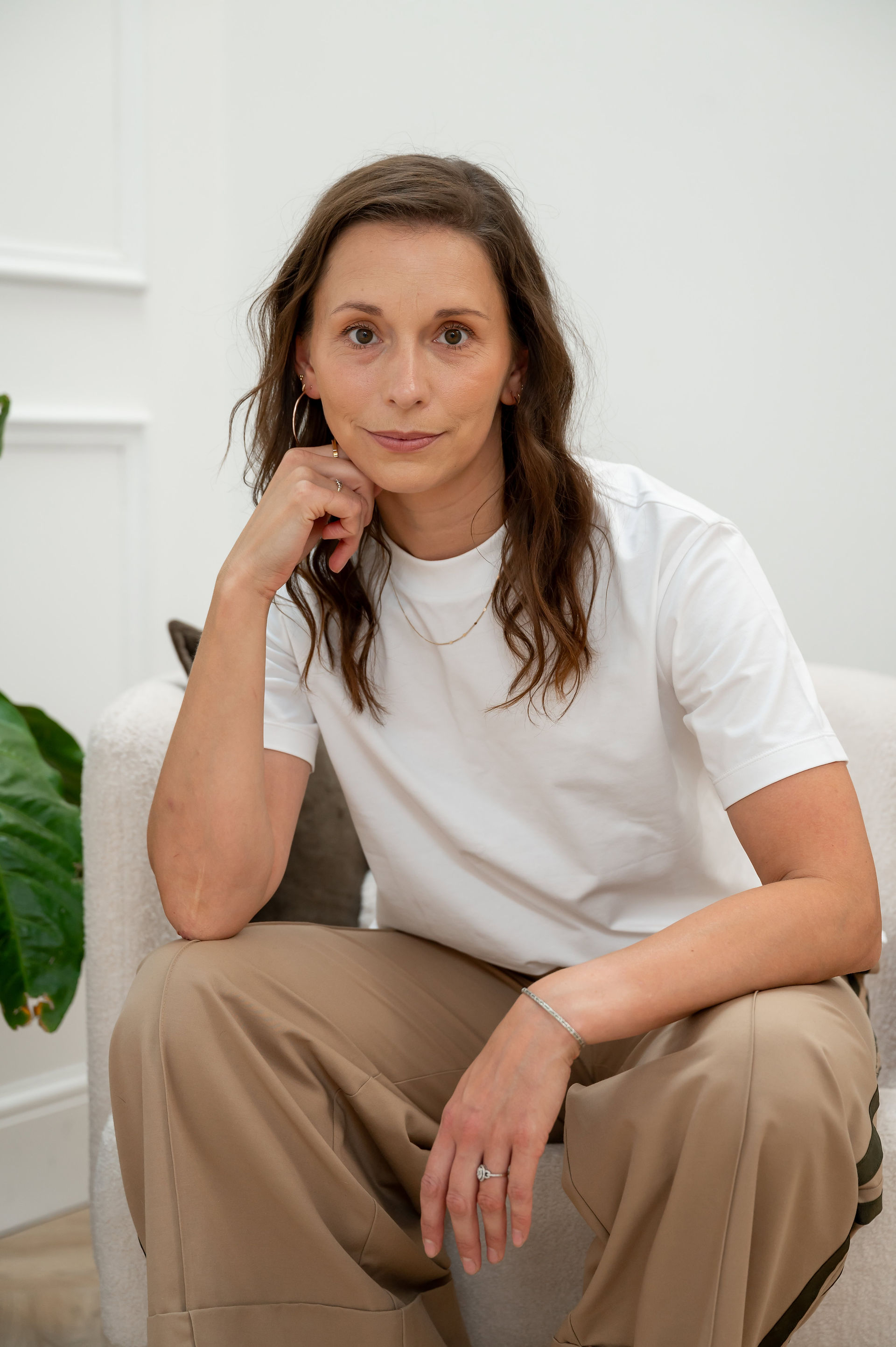 Dr. Becky Cox from Surviving in Scrubs sits in casual clothing during her brand shoot in Liverpool.
