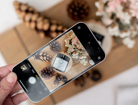 Up close of someone taking a photo with their phone of their wellness products.