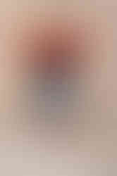 Web designer barefoot in jeans and a crop top, striking a playful pose with arms outstretched.