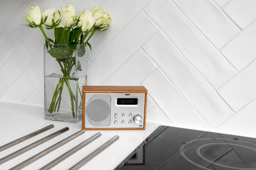 Styled brand photo with vintage radio and flowers in wellness kitchen.