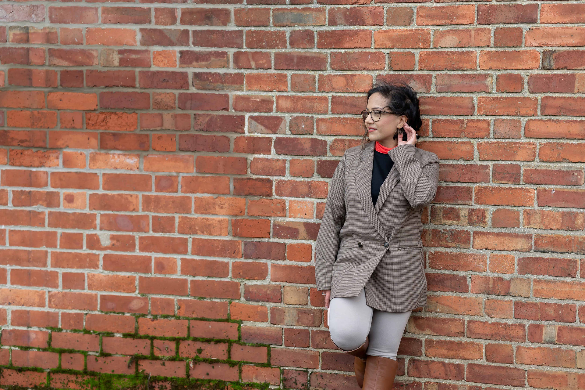 Leicester contract lawyer standing against brick wall during brand photoshoot.